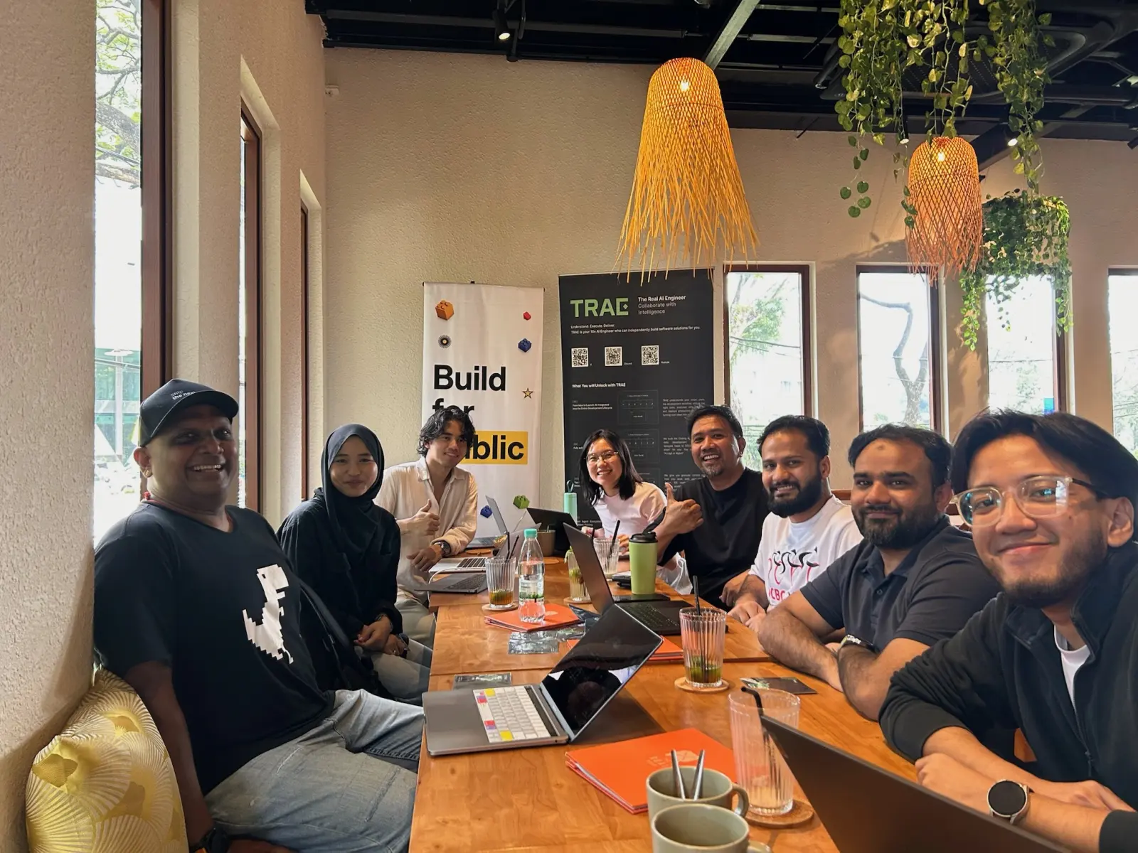 The whole table of builders at the first Build for Public meetup, banner behind them